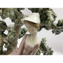 Lladro figure, Reminiscing, modelled as a woman sat on a bench under a tree, with original box, no 1270, year issued 1974, year retired 1987, H36cm