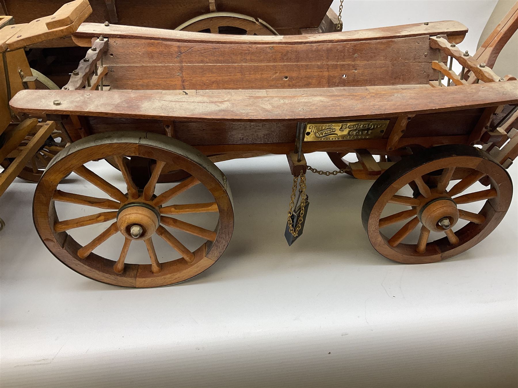 Four Melba Ware Shire horse figures and another similar, and three wood carts
