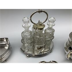 Quantity of silver plate, to include two cruet stands, one example with four cut glass bottles, three piece tea set with oblique gadrooned rims, a further smaller three piece tea set with foliate decoration, knife rests, selection of various flatware, etc. 