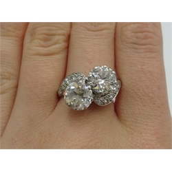  White gold two stone diamond cross-over ring with diamond shoulders, main diamonds approx 1.25 carat each, stamped PLAT 18CT  