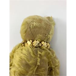 Early 20th century English teddy bear, with wood wool filled body with jointed limbs, felt covered paw pads, five claw stitching to feet and elongated arms with spoon shaped paws H14