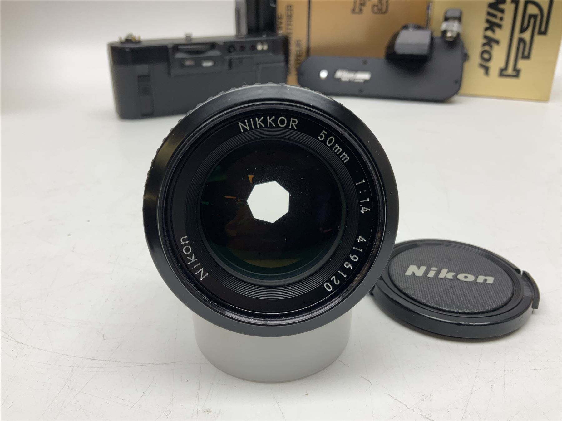 Nikon F3T camera body, in champagne/ titanium colourway, serial no. T8215031, with 'Nikon Nikkor 50mm 1:1.4' lens, Nikon MD4 motor drive, serial no. 156592 and Nikon MK-1 Firing range converter, all with original boxes 