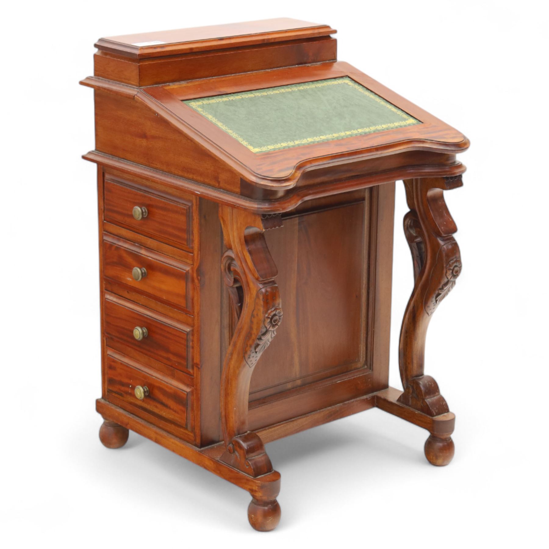 Victorian design mahogany Davenport desk, the sloped writing surface inset with tooled green leather and hinged to reveal a fitted interior, with a pen compartment to the raised gallery back, four drawers to each side, on carved scrolled supports with acanthus detail, raised on turned feet