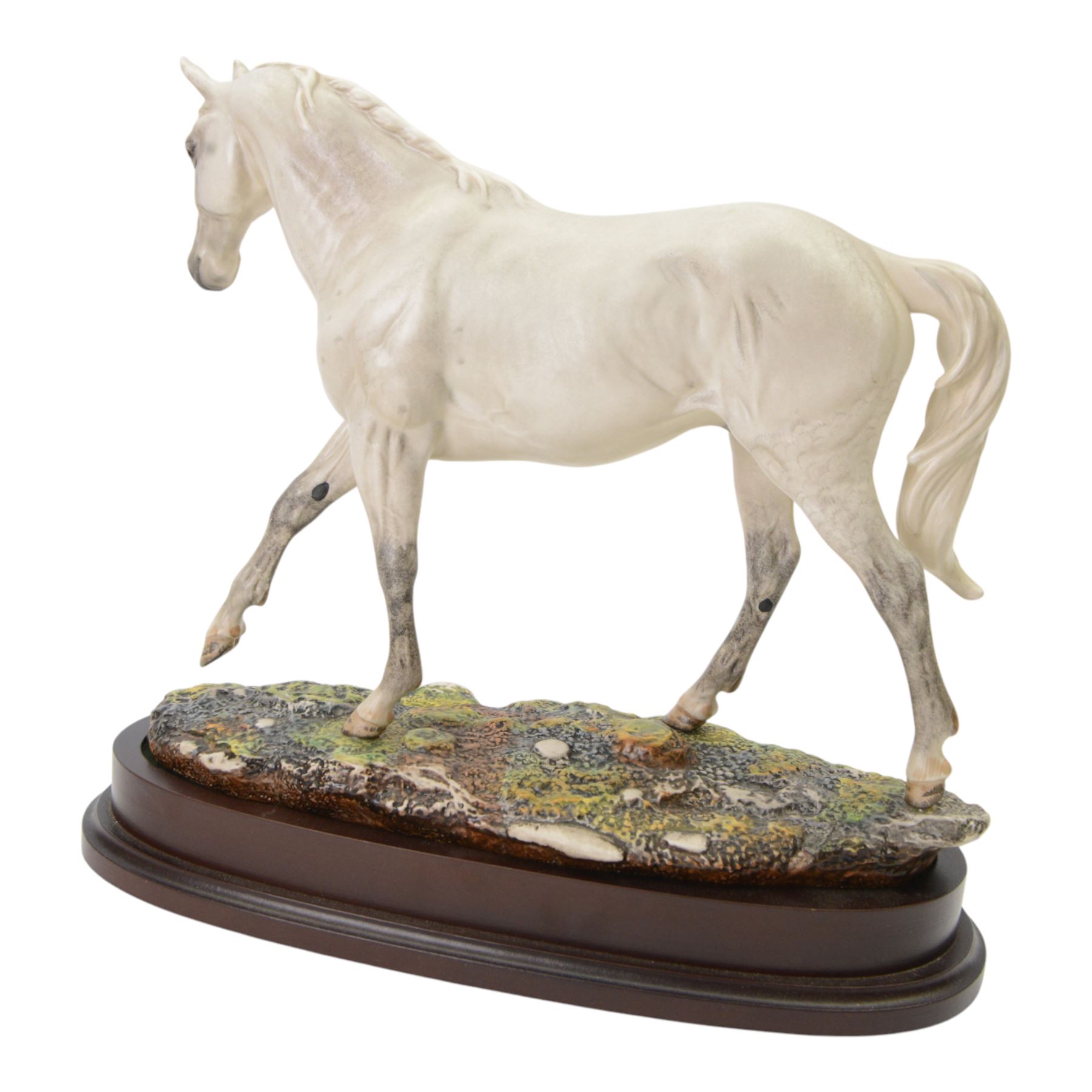 Two Royal Doulton horses, Desert Orchid and Red Rum, on wooden plinths 