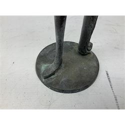 Bronze figure of a female nude with long flowing hair in stretched pose raised on circular base, H35cm