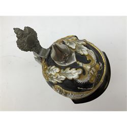 Otto Von Bismarck figural 0.5l stein, his black pickelhaube helmet with chrome spike serving as the lid, in green uniform and gilt detail throughout, pewter thumb hinge, with blue hash Musterschutz type mark, H18cm
