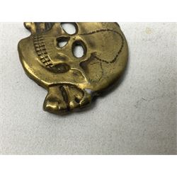 Two WW2 German 'SS' visor cap skull badges and another later; and visor cap eagle insignia (4)