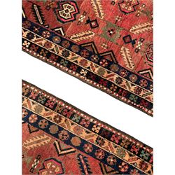 Near pair of Persian Azerbaijan red ground runners, each rug decorated with Nazarlik and stylised leaf motifs, enclosed with three band border decorated with flower heads and geometric motifs 

406cm x 99cm 
409cm x 102cm
