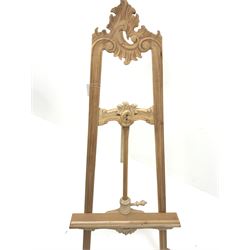 Large hardwood easel, carved scrolls and foliage
