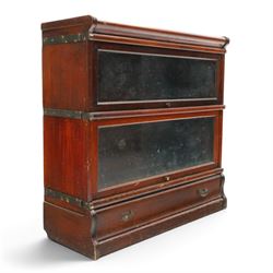 Globe Wernicke - early 20th century mahogany two-tier stacking library bookcase, fitted with glazed up-and-over doors, two drawers to the plinth base; together with a similar single-tier example (W87cm D27cm H54cm)