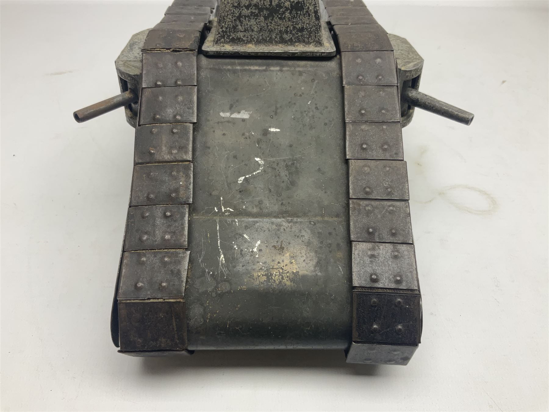 Large clockwork model of a WW1 Tank made of tin-plate and aluminium, with moving side cannons, the clockwork chain driven movement driving the articulated tin tracks; L28.5cms  W16.5cms and H13.5cms