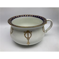 Early 20th century Bishop and Stonier four piece toilet set, comprising washbowl, wash jug, toothbrush pot, and chamber pot, each  decorated with deep blue band and husk swags and festoons in gilt, with printed Caduceus Bisto marks beneath and printed retailers mark 'Manufactured for Harrods Limited London', wash bowl D43cm, wash jug H31.5cm