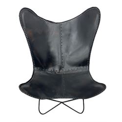 Metal framed butterfly chair upholstered in slung dark tan stitched leather 
