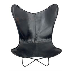 Metal framed butterfly chair upholstered in slung dark tan stitched leather 

