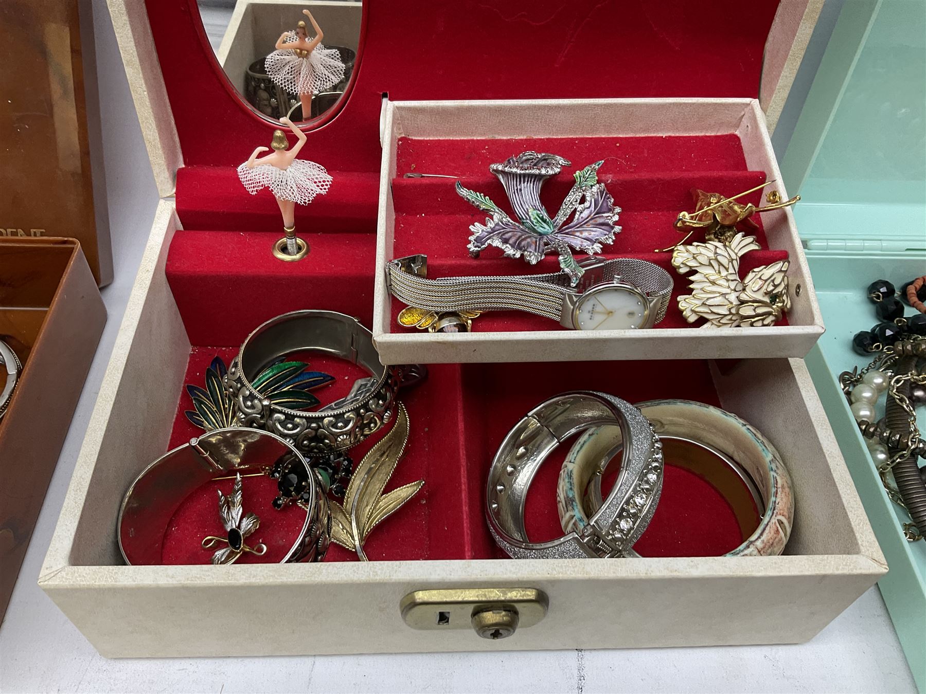 Collection of costume jewellery including enamel and marcasite flower brooch, two V Villani Italy bangles, clip on earrings, brooches, bangles, beaded necklaces and a Skagen wristwatch