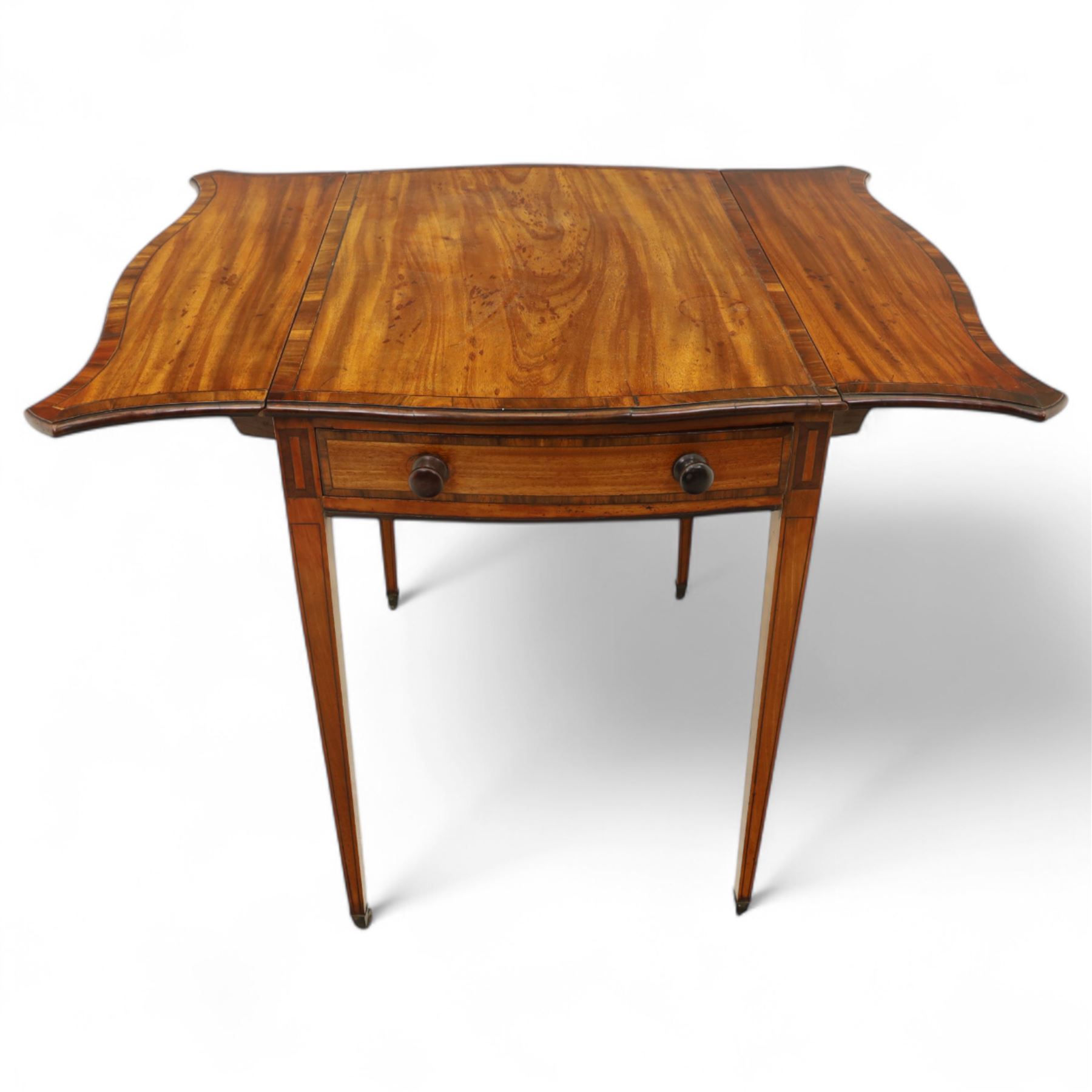 Goergian small butterfly pembroke table, the rectangular top with crossbanded edge and rounded drop leaves, single frieze drawer with opposing dummy drawer, raised on square tapering legs with stringing, terminating in brass castors