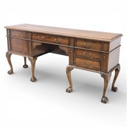 Georgian design mahogany sideboard, the rectangular top with moulded gadrooned edge, fitted with a central frieze drawer flanked by cupboard doors, raised upon cabriole legs terminating in ball and claw feet