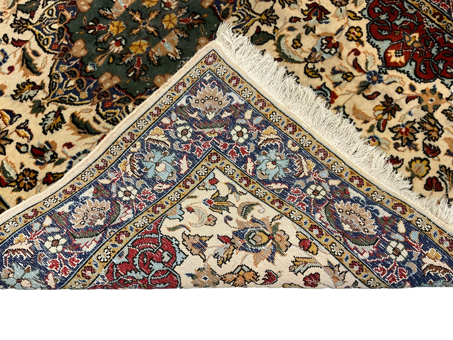 Persian ivory ground rug, central green floral pole medallion within a field decorated by scrolling foliate patterns, the guarded border with repeating palmettes and floral designs