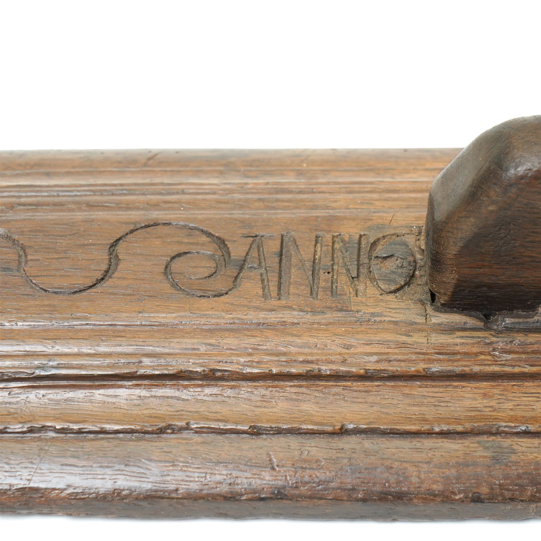 18th century oak mangle board, carved with scrolled motifs, incised 'ANNO 1717', W57cm 