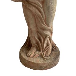 Pair of terracotta garden figures, classically depicted putto draped in linen carrying bird’s nest, on shaped plinth base