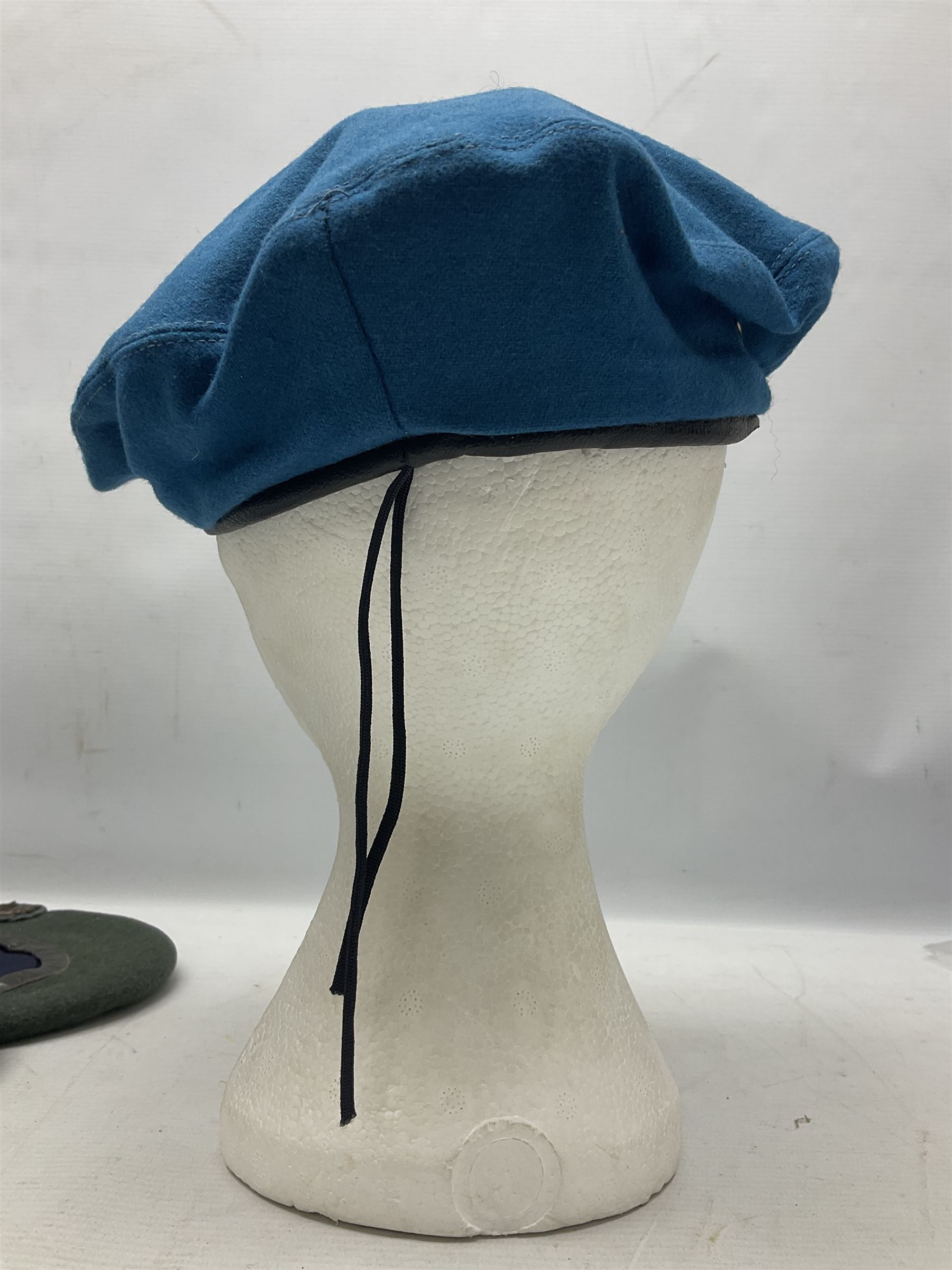 Four paratrooper berets - Russian, Italian, British and Foreign Legion; all with badges (4)