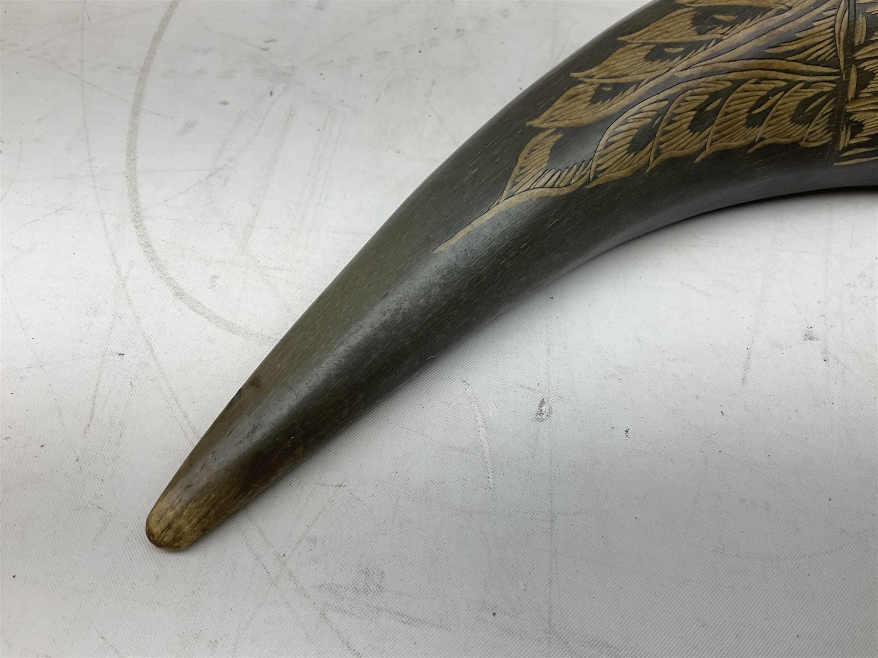 Carved water buffalo horn wall pocket, engraved with landscape scene with patterned borders with pierced foliate panel, together with a pair of horns with similar engraved decoration, L47cm