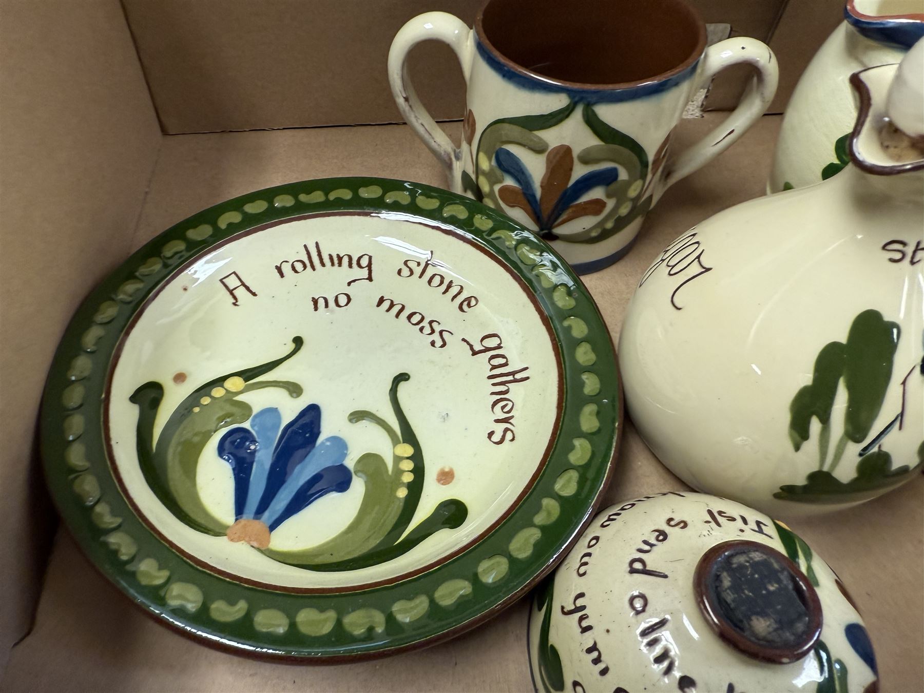 Collection of Torquay and similar Motto ware, including jugs, candlesticks, twin handled mug etc 