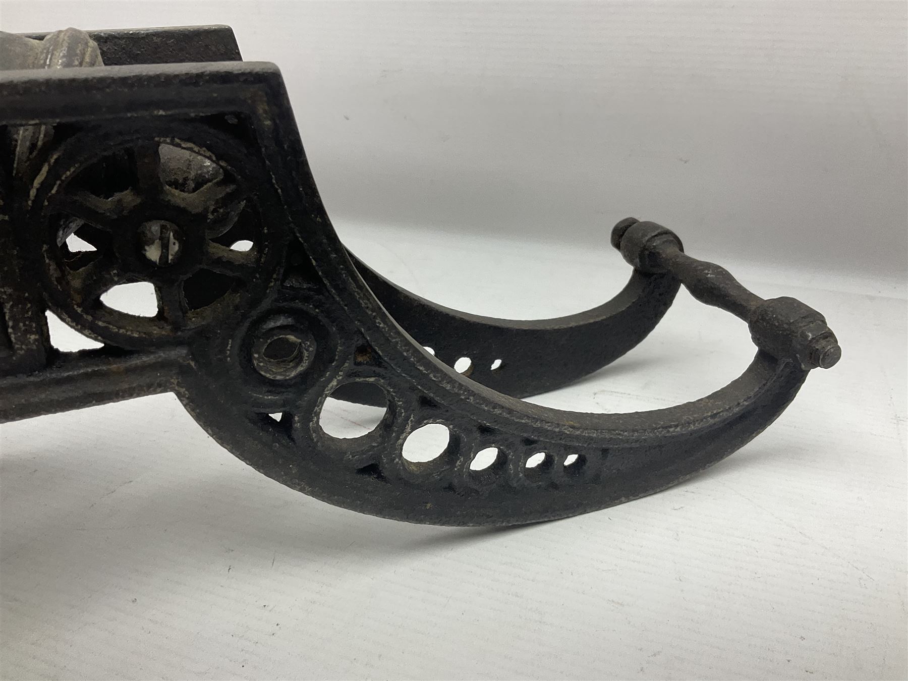 Victorian cast-iron and steel signal cannon, approximately half-inch bore, with 23cm ringed barrel and cylindrical trunnions, on a cast iron carriage with two twelve-spoked wheels and guilloche pierced swept back support, L43cm overall