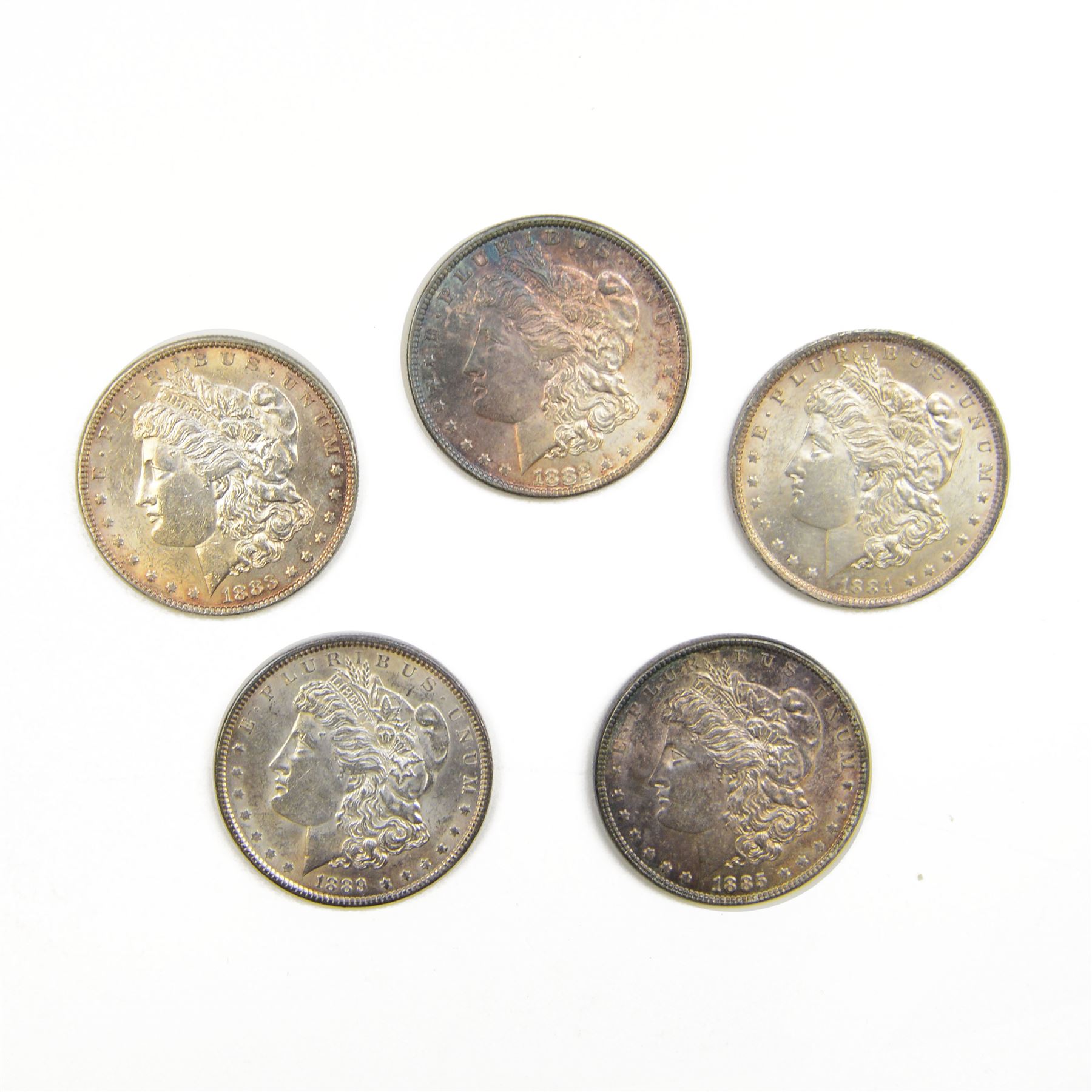 Five United States of America silver Morgan dollar coins, dated 1882, 1883, 1884 O, 1885 and 1889