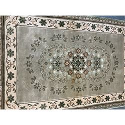 Three Chinese washed woollen rugs - circular blue ground decorated with dragons (D160cm), rectangular light green rug (185cm x 123cm), and a rectangular green rug (185cm x 123cm)