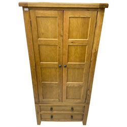 Oak double wardrobe, fitted with panelled doors enclosing hanging rail, fitted with two drawers to the base