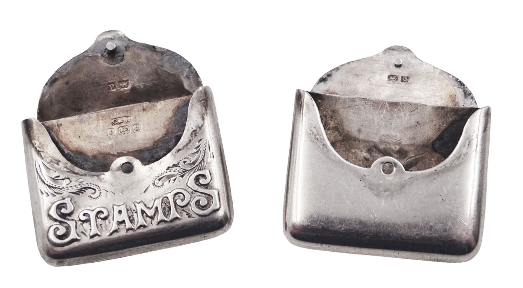 Two Edwardian silver stamp holders modelled in the form of envelopes, the first example detailed 'Stamps', hallmarked Crisford & Norris Ltd, Birmingham 1903, the second of plain form, hallmarked Crisford & Norris Ltd, Birmingham 1902, approximate total weight 0.38 ozt (11.8 grams)