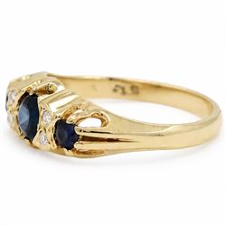 Gold sapphire and diamond ring, three round cut sapphires spaced by four single cut diamond accents, stamped 18ct