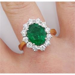 18ct gold oval emerald and round brilliant cut diamond cluster ring, hallmarked, emerald approx 2.35 carat, total diamond weight approx 0.75 carat