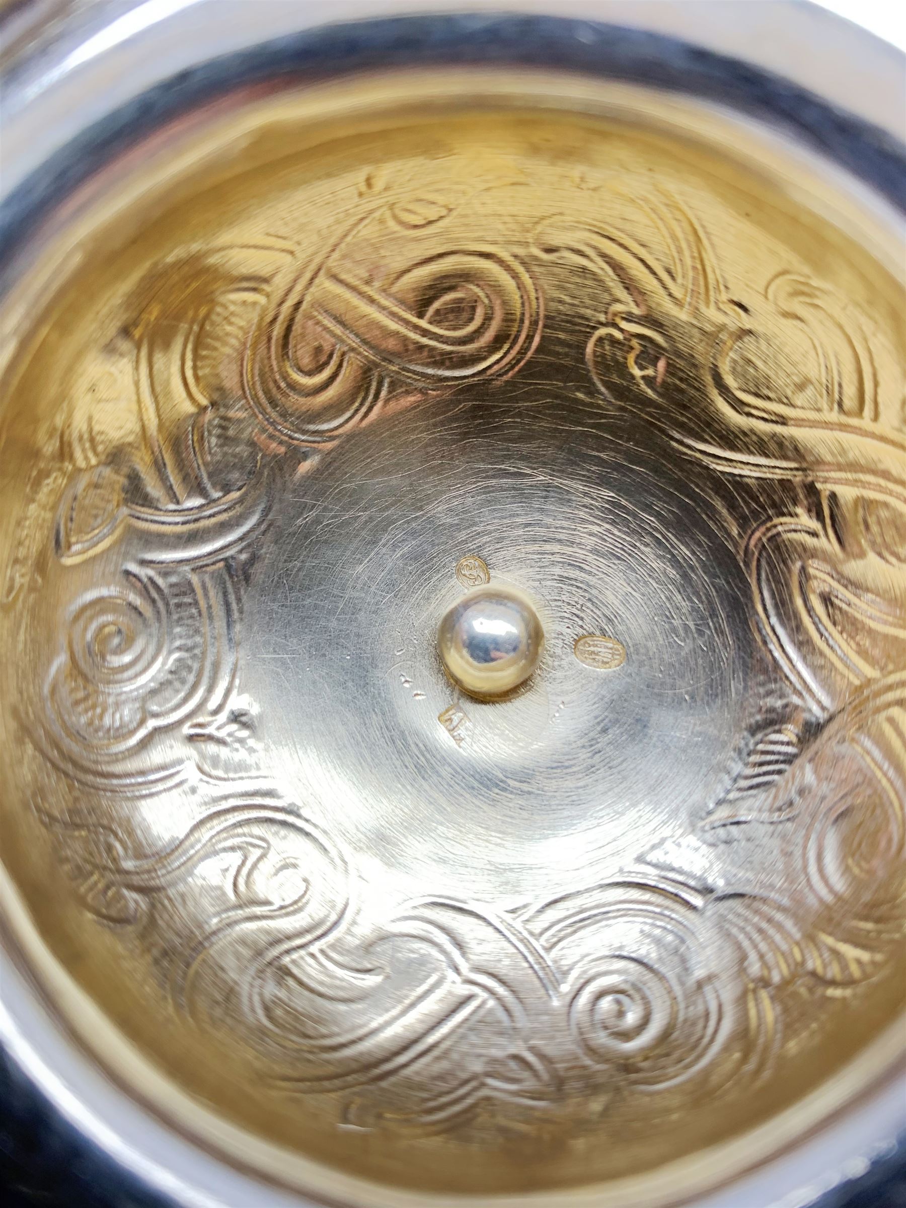 Late 19th century Danish silver drinking horn and cover, the body with hexagonal and beaded finial, raised upon two talon feet and further scroll foot, chased with scrolling foliate and zoomorphic bands, the detachable domed cover with conforming decoration surmounted by a figure holding a hammer, the cover interior impressed with maker's mark (partly worn and indistinct), alongside Danish Three Towers mark for 1881, with the Assay Master mark for Simon Groth (1863-1904), H23.5cm, weight 14.75 ozt (459 grams)

