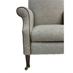 Interiors at Nine to Eleven - Edwardian design armchair, traditional shape with rolled arms, upholstered in 'Harris Tweed' fabric with leather piping, raised on square taping supports with castors