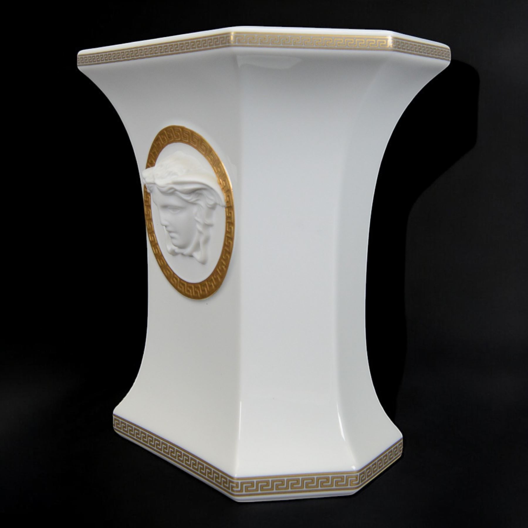 Rosenthal Versace Gorgona vase, of rectagular form with fluted base and rim, decorated in relief with medusa masks and gilt greek key borders upon a white ground, boxed, H19cm