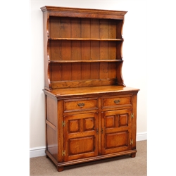  Medium oak dresser, two tier plate rack above two drawers and two panelled doors, by 'S. Cumper Ltd. Salisbury', W111cm, H187cm, D52cm  