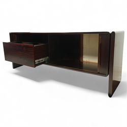 Dyrlund  - contemporary Santos rosewood office sideboard of minimalist form with clean lines, rectangular top with integrated side supports, left side with two drawers, and right side with a filing drawer, all enclosed by sliding doors


Note: Dyrlund is a Danish furniture manufacturer known for its high-quality, handcrafted pieces, particularly in the mid-century modern style. Founded in 1960 by Frits Hjerte Dyrlund in Rude, Denmark, the company has remained a family business, now run by the second and third generations. Dyrlund specializes in both home and executive office furniture, focusing on practicality, solid construction, and classic design. 
