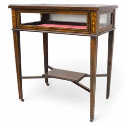 Edwardian rosewood bijouterie cabinet, the hinged rectangular top with line inlay enclosing a velvet lined interior, upon slender tapering legs inlaid with satinwood foliate marquetry decoration, with stretchers united by an under tier, raised on castors 