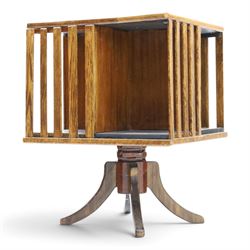 Early 20th century oak revolving bookcase, square top above four divided sections, raised on a revolving base