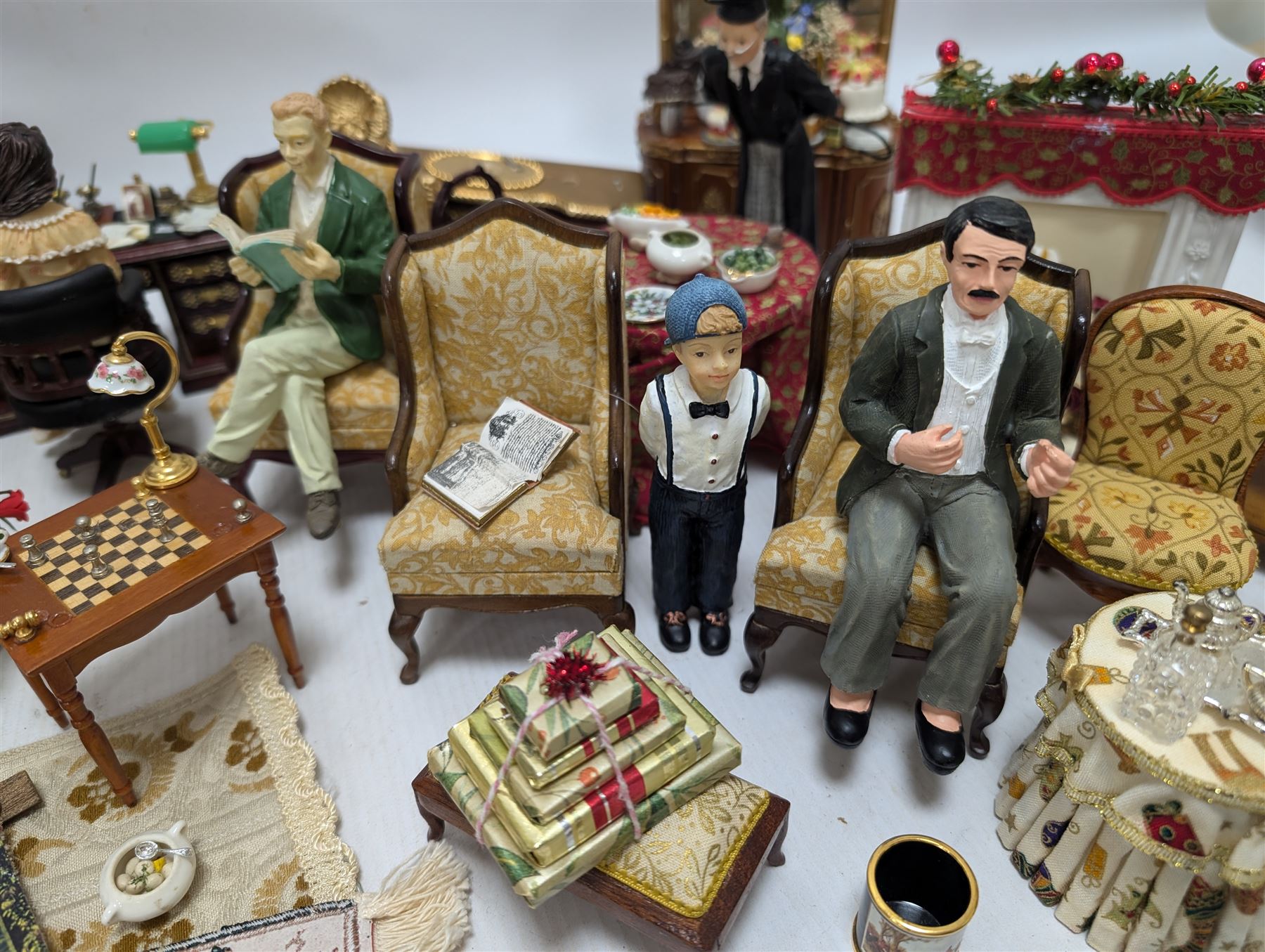 Dolls house living room and dining room furniture, including arm chairs, desk, fireplaces, dressers, tables, eight figures and a large collection of predominantly Christmas themed food, accessories and decorations