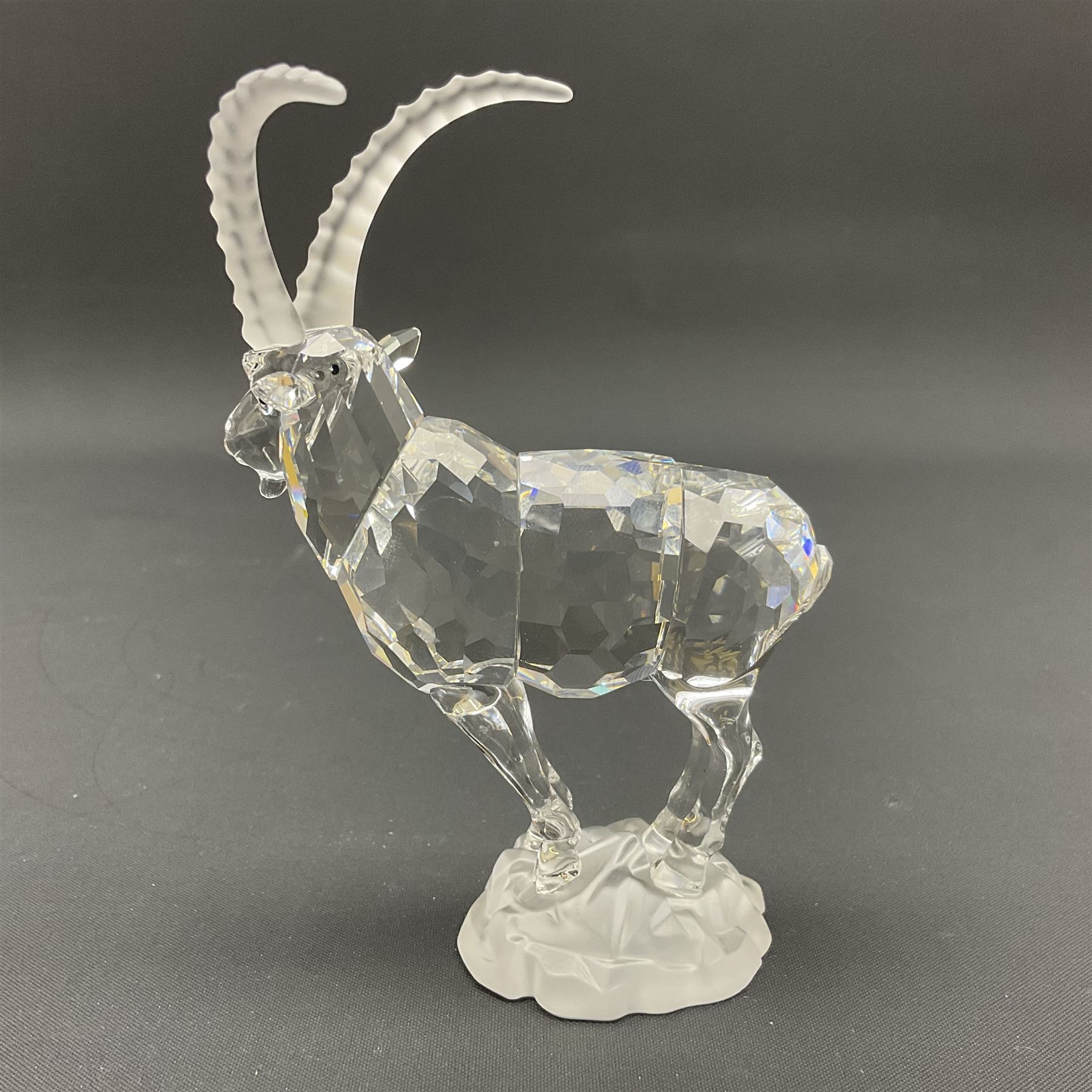 Swarovski Crystal animals, comprising white peacock, the tail with cascading blue flowers, perched eagle with yellow beak, ibex with frosted crystal horns and unicorn with frosted crystal horn, tallest H13cm