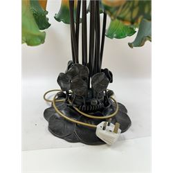Art Nouveau Tiffany style table lamp, the bronzed base modelled as lily pads leading to tendrils and twelve branches supporting green and yellow glass lily flower shades, H53cm