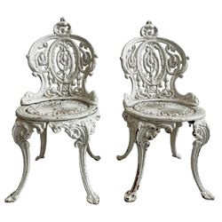 Pair of Victorian white painted cast iron garden chairs, the cresting rail with cartouche over scrolls and trailing bellflower decoration, circular seat on scroll cast cabriole supports