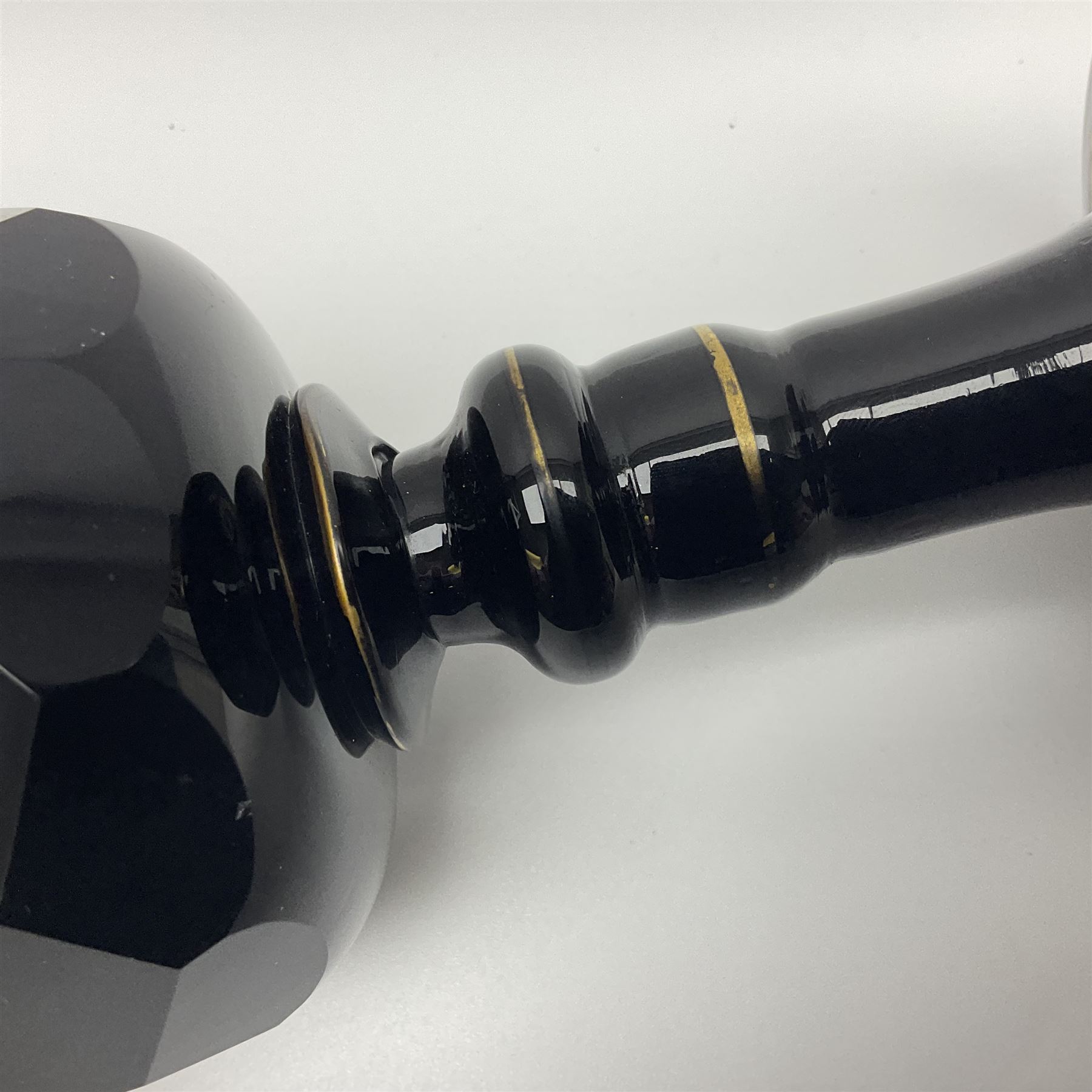 19th Century Bohemian amethyst glass lidded goblet, the bowl of faceted form, gilded with three children in period dress playing games, upon a knopped stem and conforming faceted foot, together with an art nouveau green glass goblet, with gilded rim, upon clear trumpet stem, and a hand blown wine glass, transfer printed with birds and three figures in period dress, tallest H29cm