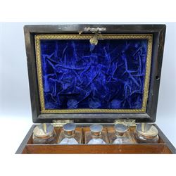 Victorian coromandel vanity box, of rectangular form with mother of pearl escutcheon and vacant plaque to the hinged cover, opening to reveal a compartmented and part plush lined interior, with hidden mirror and envelope compartment contained behind a crushed and gilt tooled partition, glass jars of various form, each with star cut base and a number with stoppers or silver plated covers, and mother of pearl handled manicure tools, H16cm L30cm D22.5cm