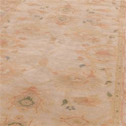 West Persian hand-knotted Ziegler design rug, ivory field decorated with an all-over lattice of stylized palmettes and floral sprays linked by angular vines, border of scrolling floral ornamentation in a palette of blush pink, sage green, powder blue, and soft ochre, with cotton fringe ends 