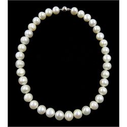 Single strand white freshwater cultured pearls with a 9ct gold ball clasp, stamped 375