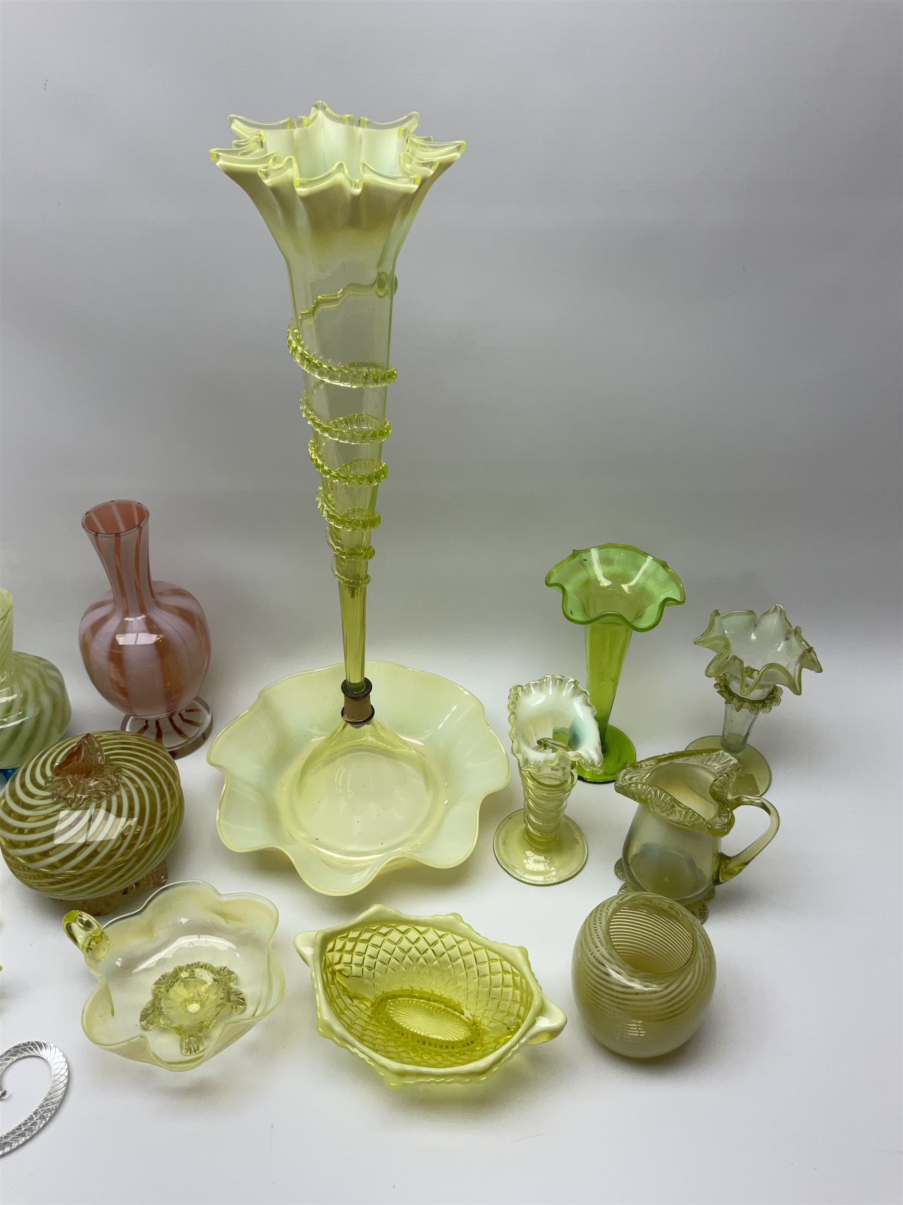 A group of Victorian and later Vaseline glass, to include part epergne, two vases with crimped rims and trailed decoration, a uranium glass vase, lemon Vaseline glass twin handled bowl, etc. 